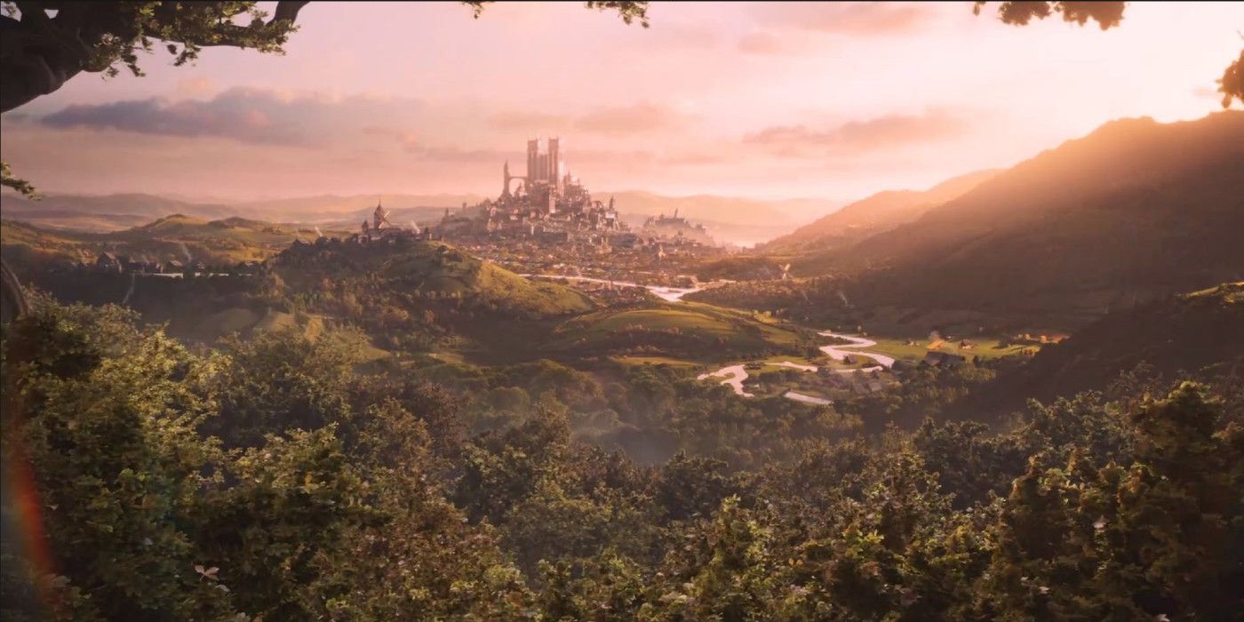A landscape from the Fable reboot, showcasing forests with a distant kingdom in the background during sunset.
