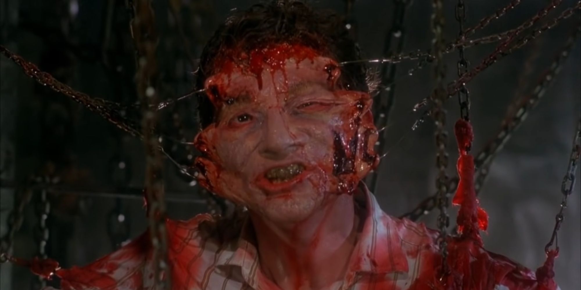 Frank Cotton being pulled apart by hooks in Hellraiser (1987)