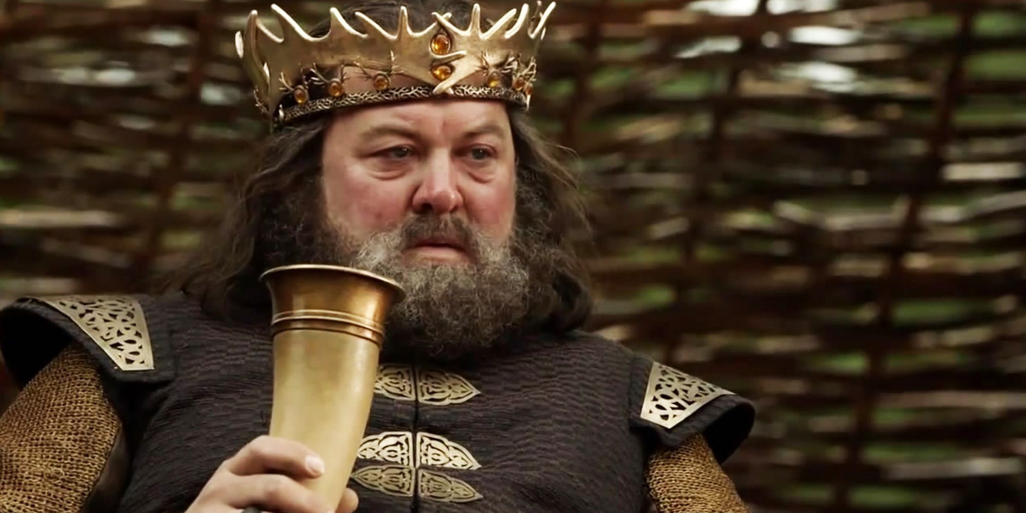 Robert Baratheon drinking and looking impatient in Game of Thrones.
