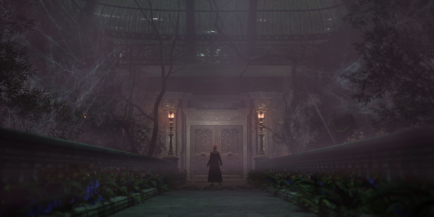 A Hogwarts Legacy character standing in front of a large room in an abandoned green house, where cobwebs cover the plants.