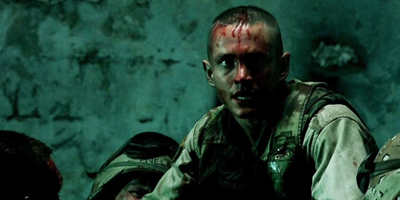Screencap of Hugh Dancy as SFC Kurt "Doc" Schmid in Black Hawk Down. Schmid's face is covered in blood as he attempts to operate on a soldier during the Battle of Mogadishu.