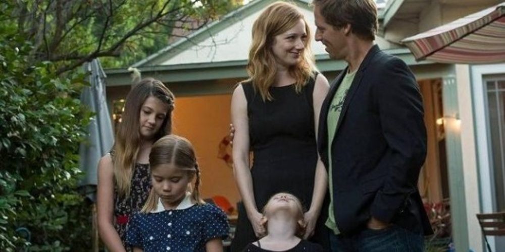 Husband and wife with their children outside the house in Married