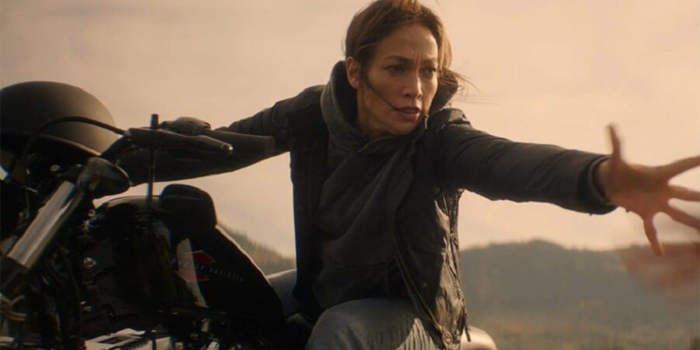 Jennifer Lopez riding a motorcycle and reaching her hand out in The Mother. 