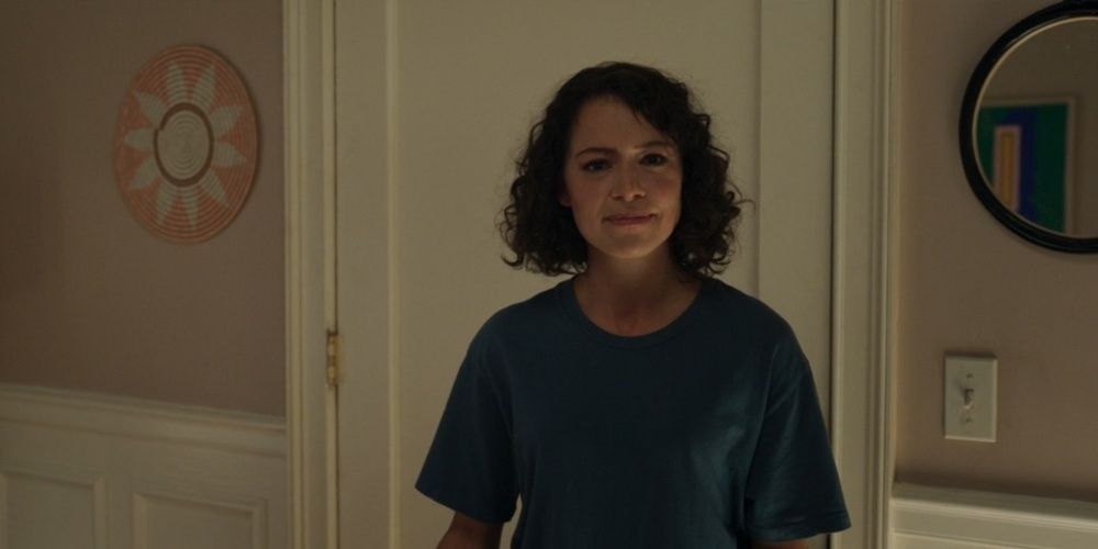 Jennifer Walters stands by the door and looks in the camera in She-Hulk