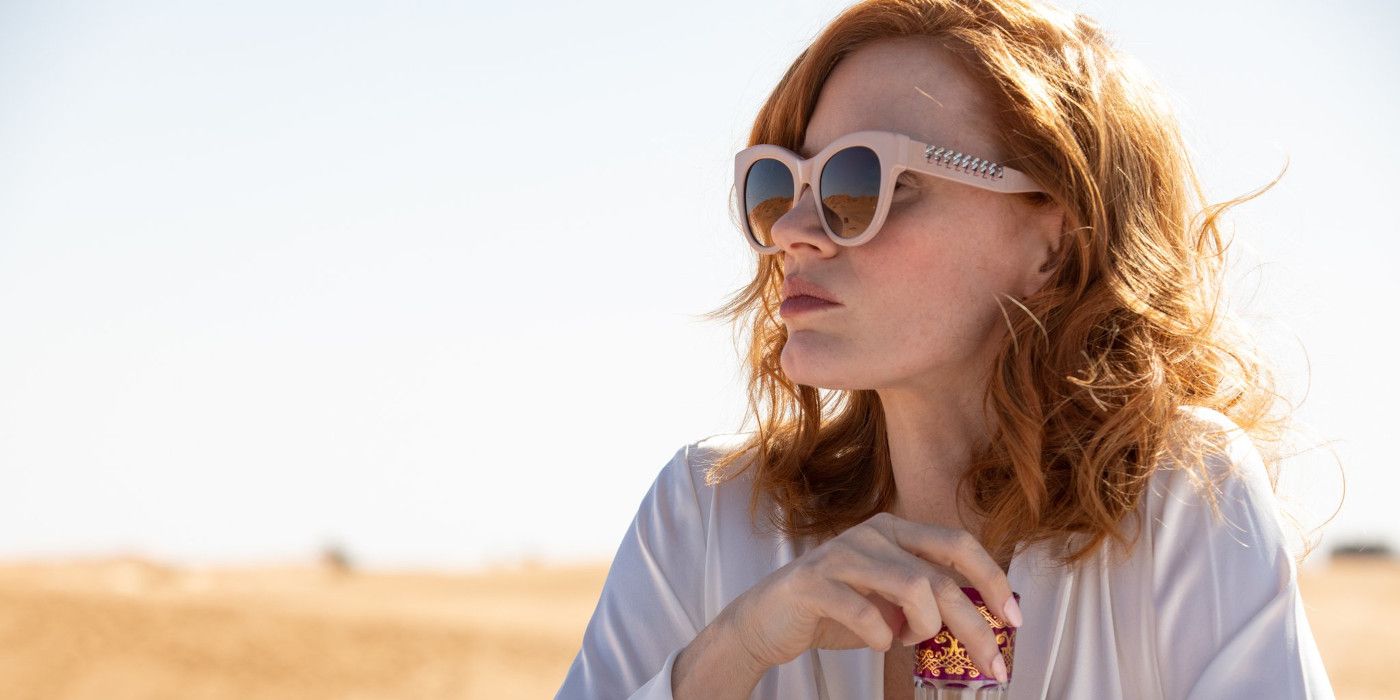 Jessica Chastain In The Forgiven in the desert wearing sunglasses and gazing into the distance.