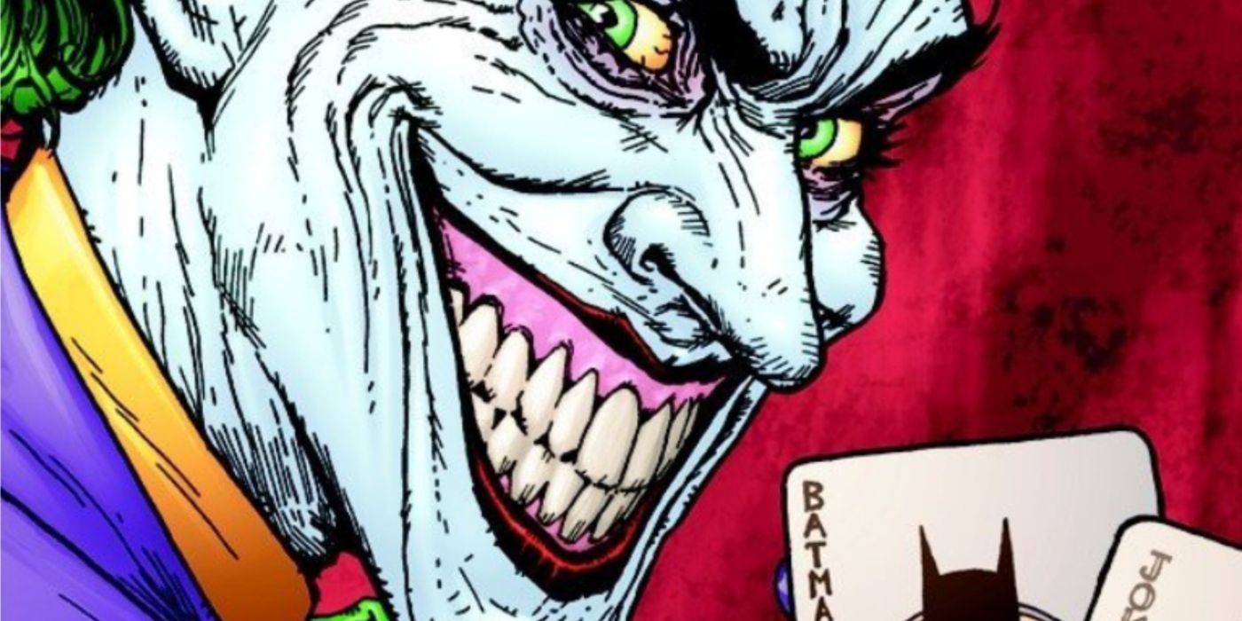 Joker smiles disturbingly as he holds up Batman and Joke playing cards.