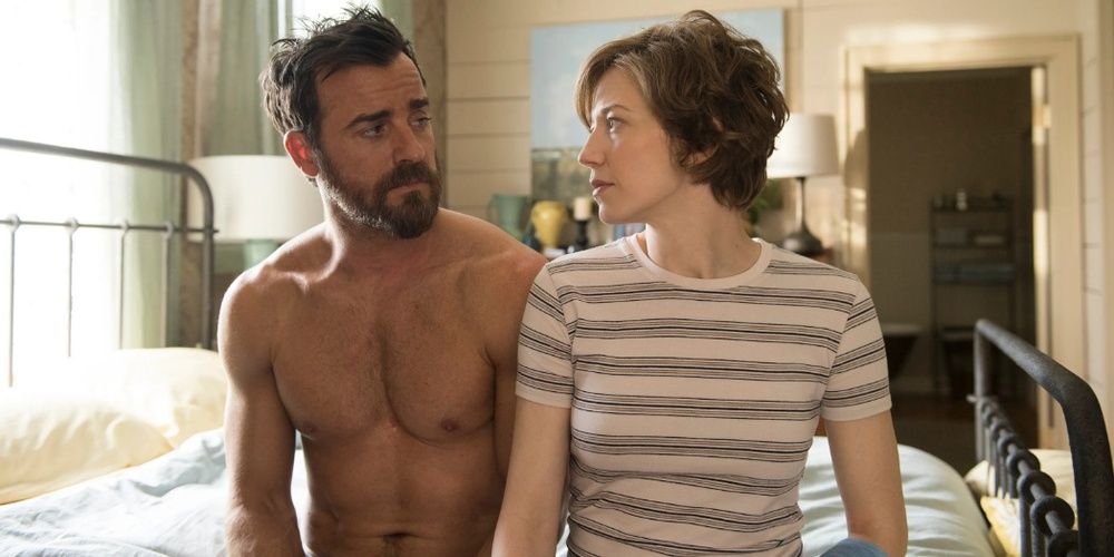 Justin Theroux and Carrie Coon look at each other in bed in The Leftovers