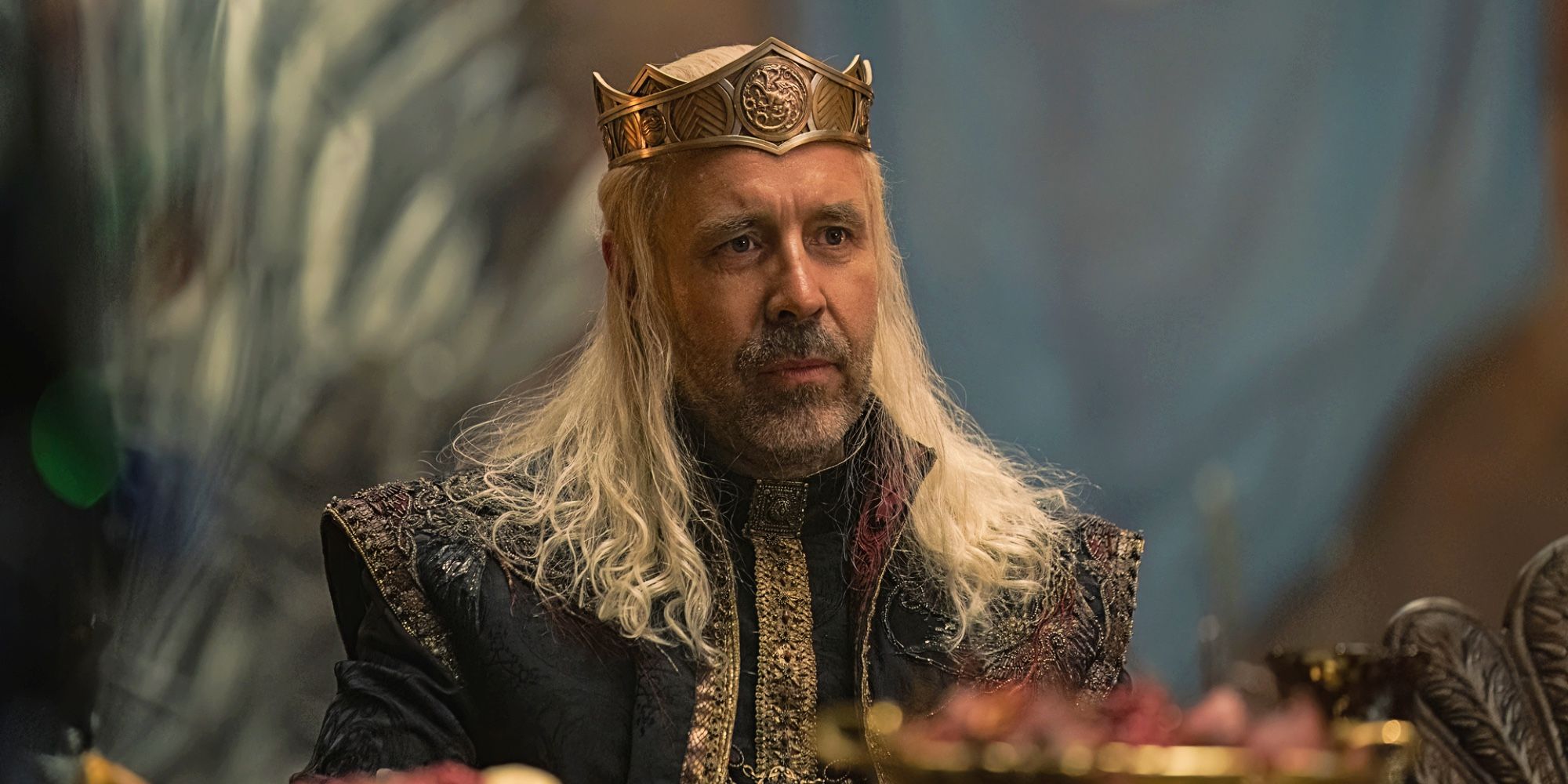 King Viserys I Targaryen sitting down and looking disheartened in House Of The Dragon.