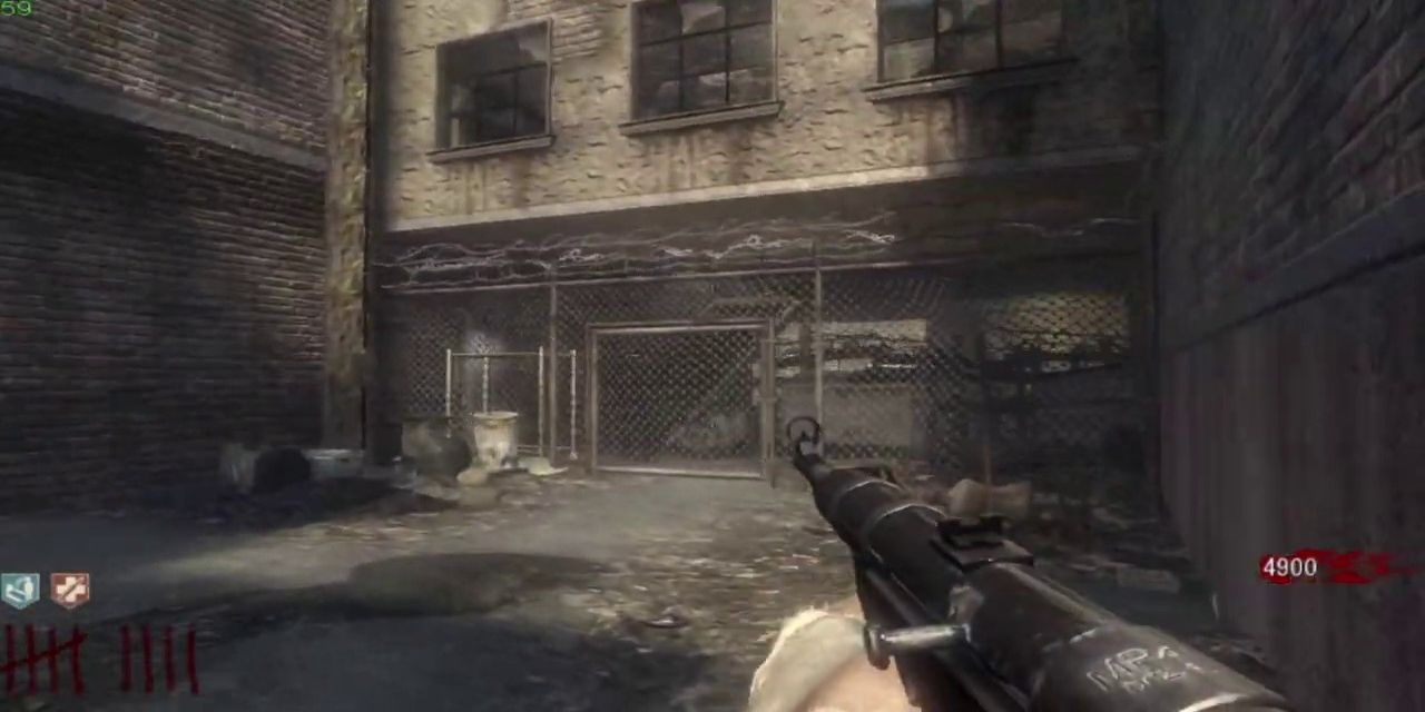 A screenshot from the video game Call of Duty Black Ops with the player holding a gun in a derelict alley.