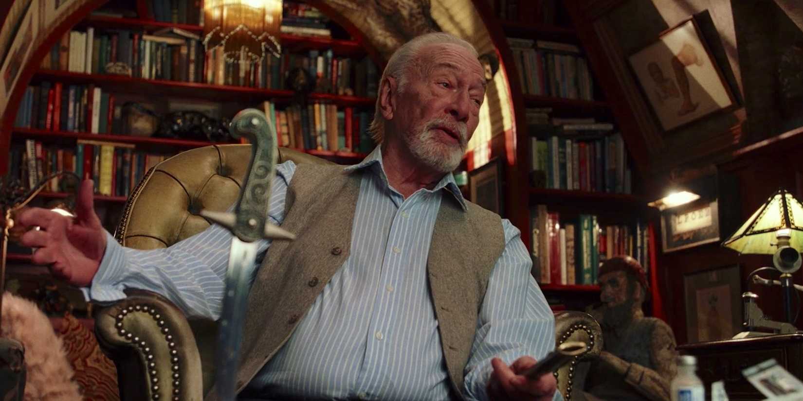 Harlan Thrombey (Christopher Plummer) stabs the table with a knife in Knives Out