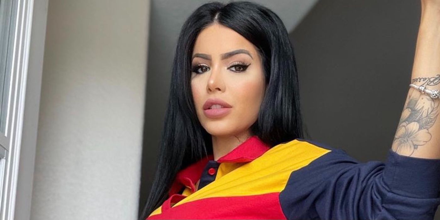 Larissa Lima from 90 Day Fiancé wearing bright blouse and makeup, showing tattoo