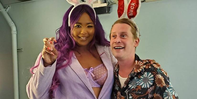 Lizzo & Macaulay Culkin wearing bunny ears and posing for a photo.