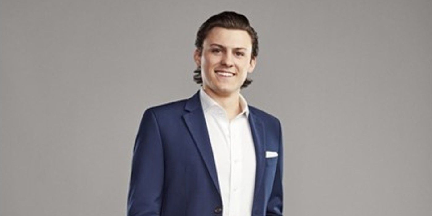 Logan Claim to Fame wearing blue suit and white shirt smiling