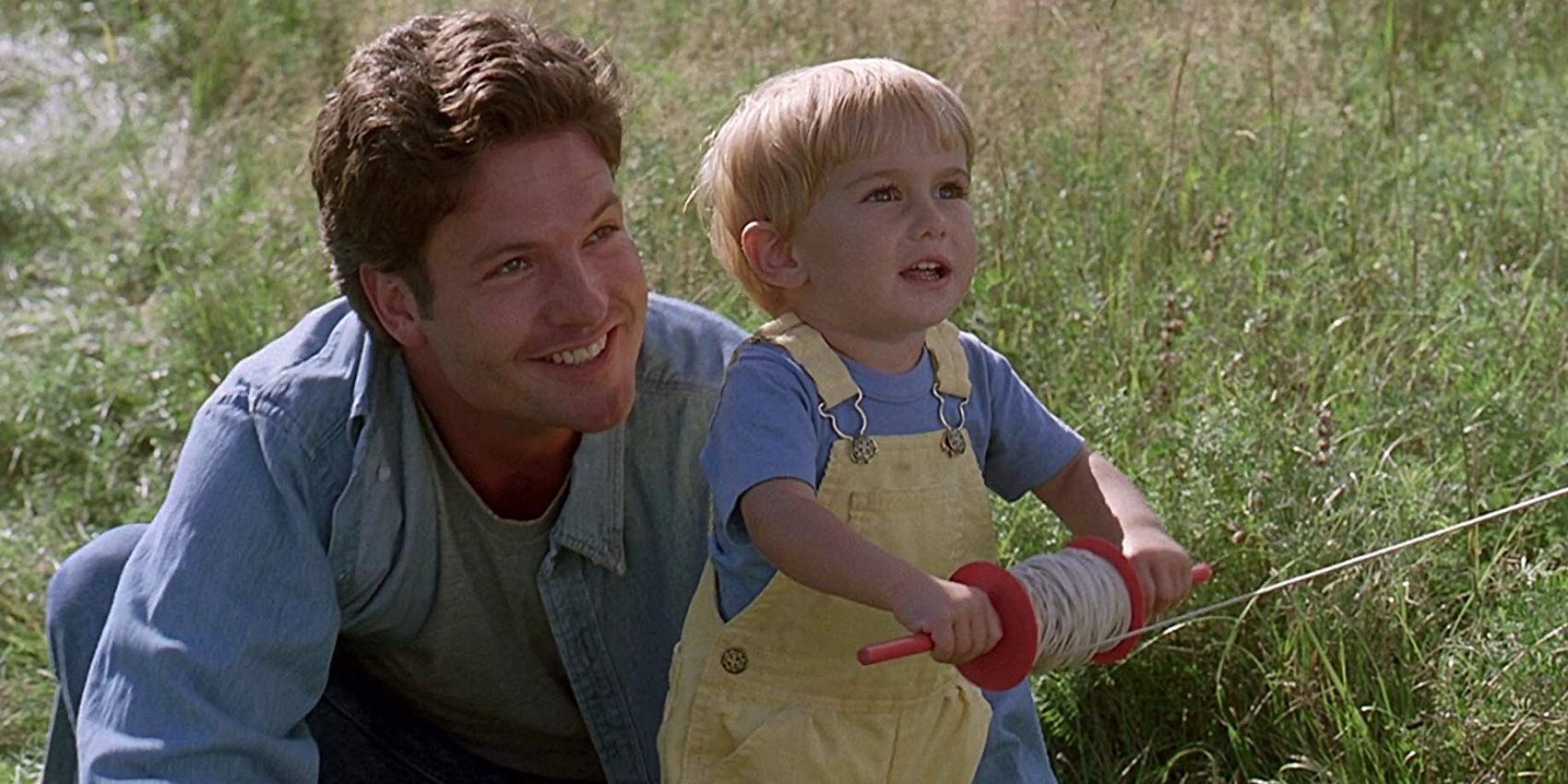 Louis in a field with his son in Pet Sematary