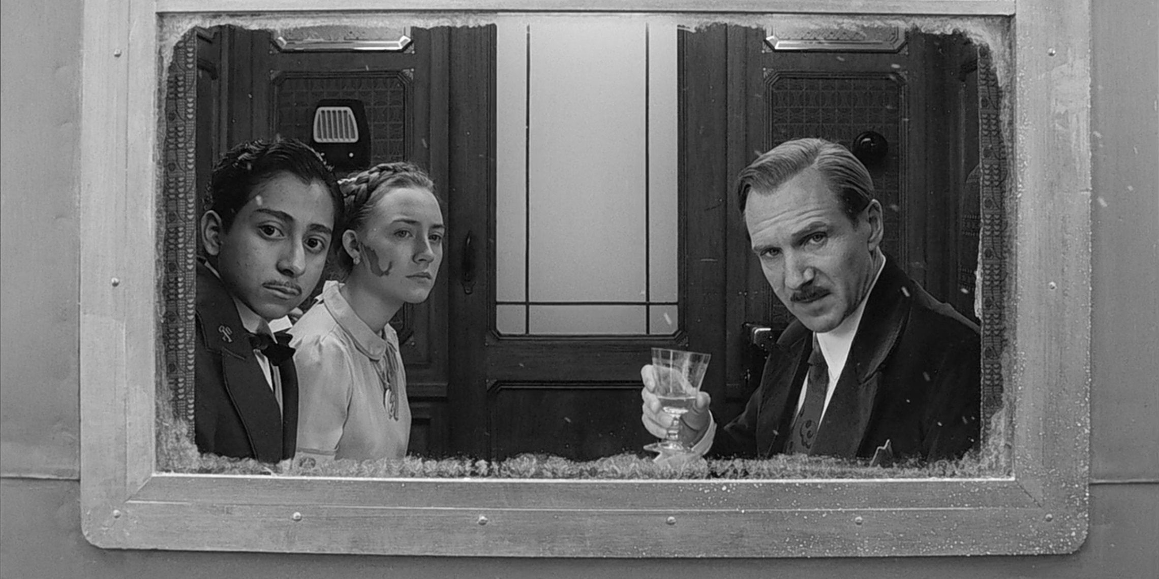 M Gustave, Zero, and Agatha riding a train in The Grand Budapest Hotel