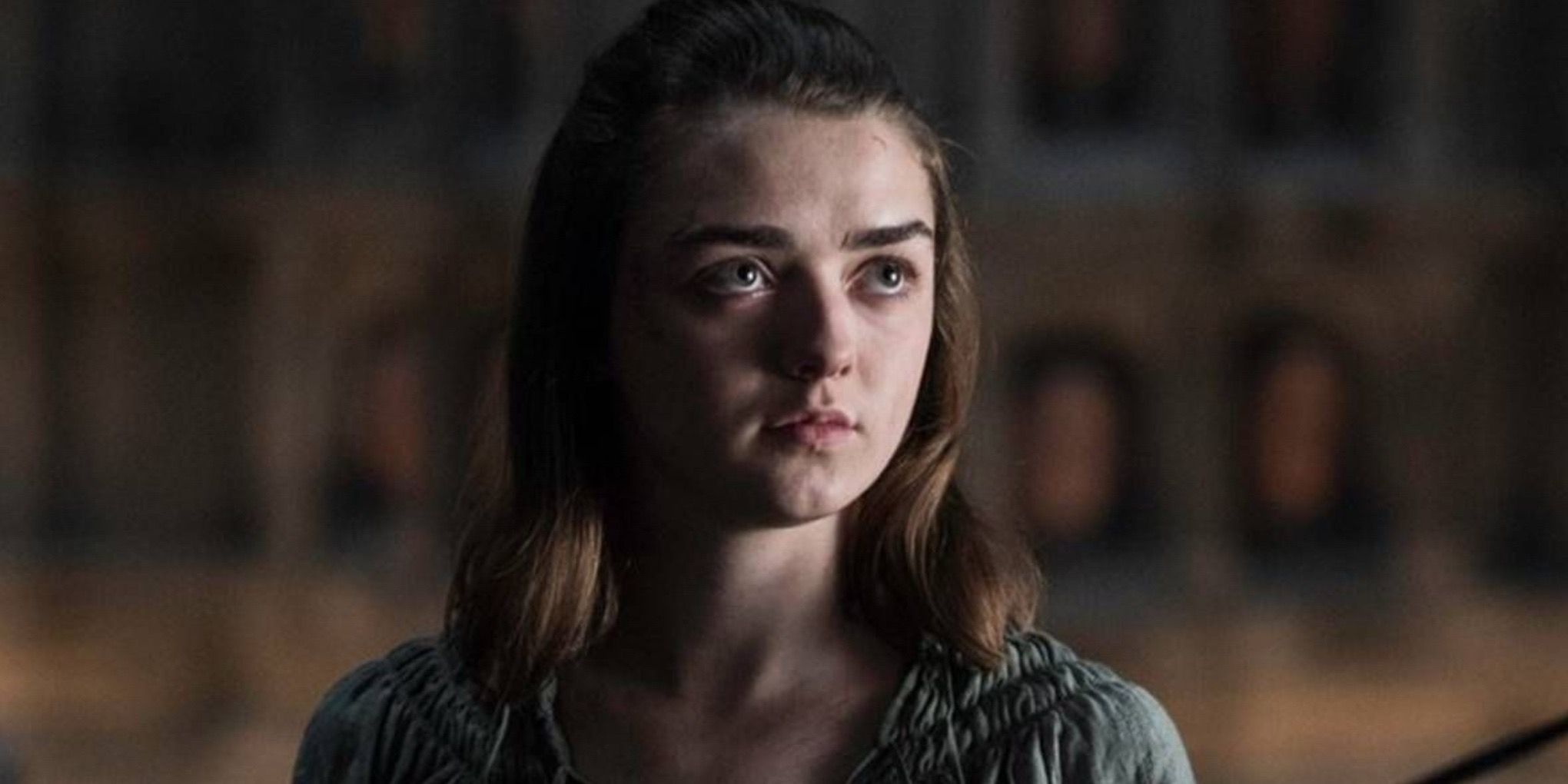 Arya Stark looking serious while pointing her sword at someone off-screen in Game of Thrones