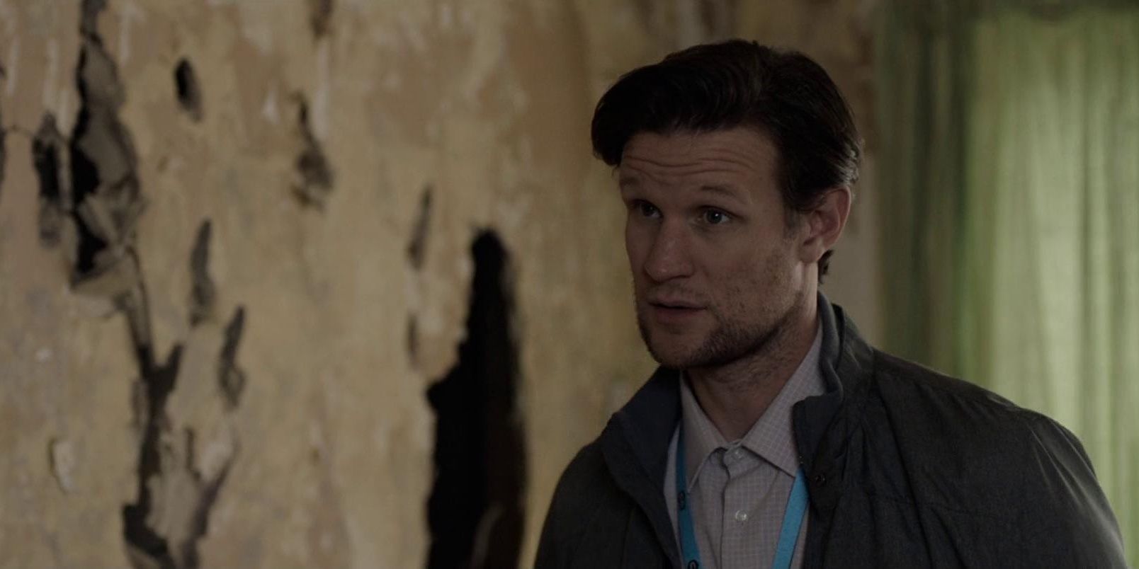 Matt Smith next to a cracked wall in His House 