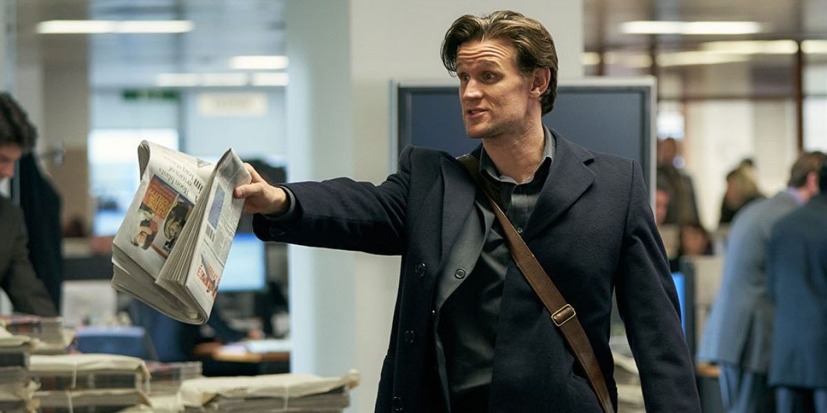 Matt Smith with a newspaper in hand in Official Secrets 