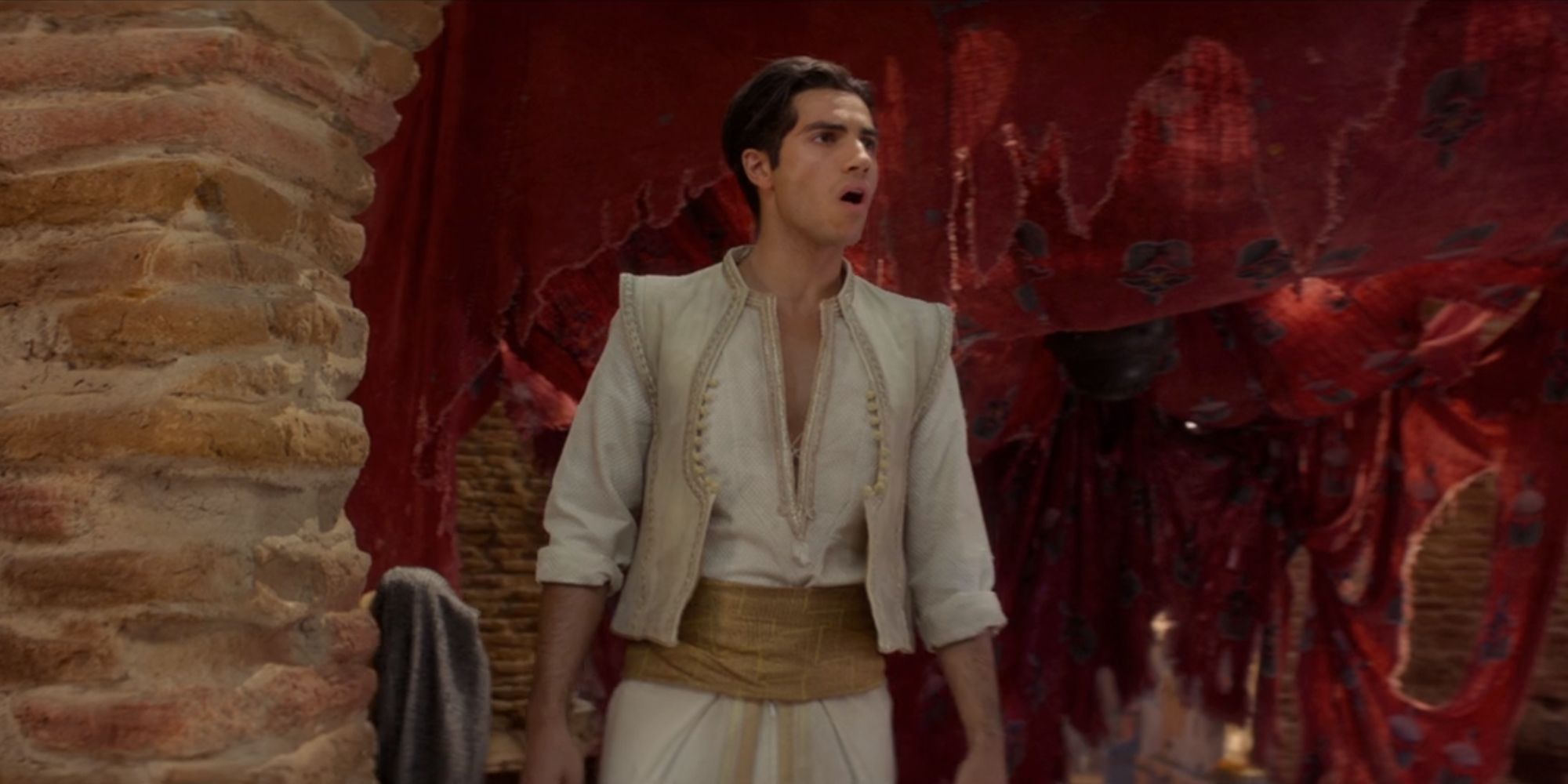Mena Massoud as Aladdin singing One Jump Ahead (Reprise 2) in his old home in Aladdin (2019)