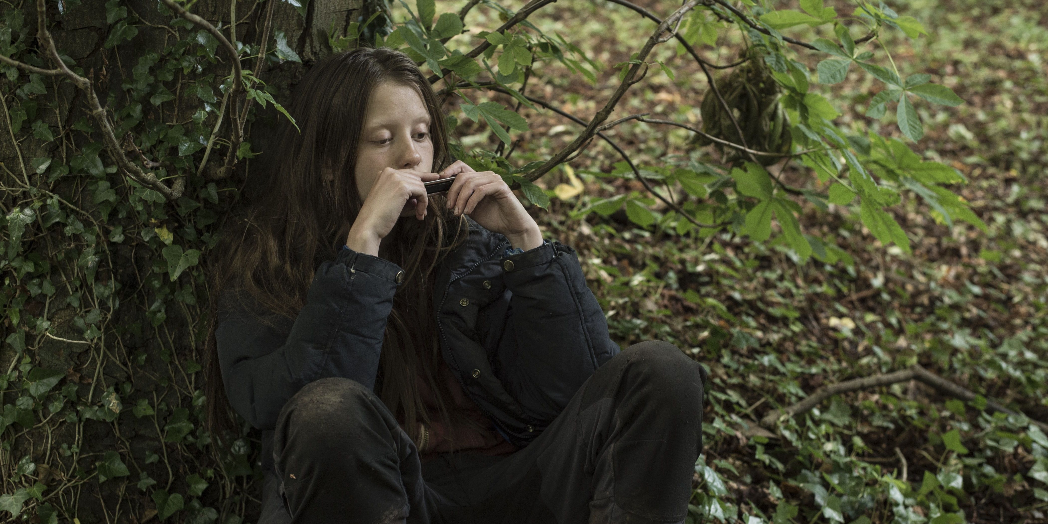 Mia Goth playing the harmonica in The Survivalist Cropped