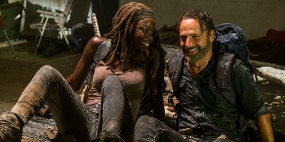 Michonne and Rick have a laugh in the mud in The Walking Dead