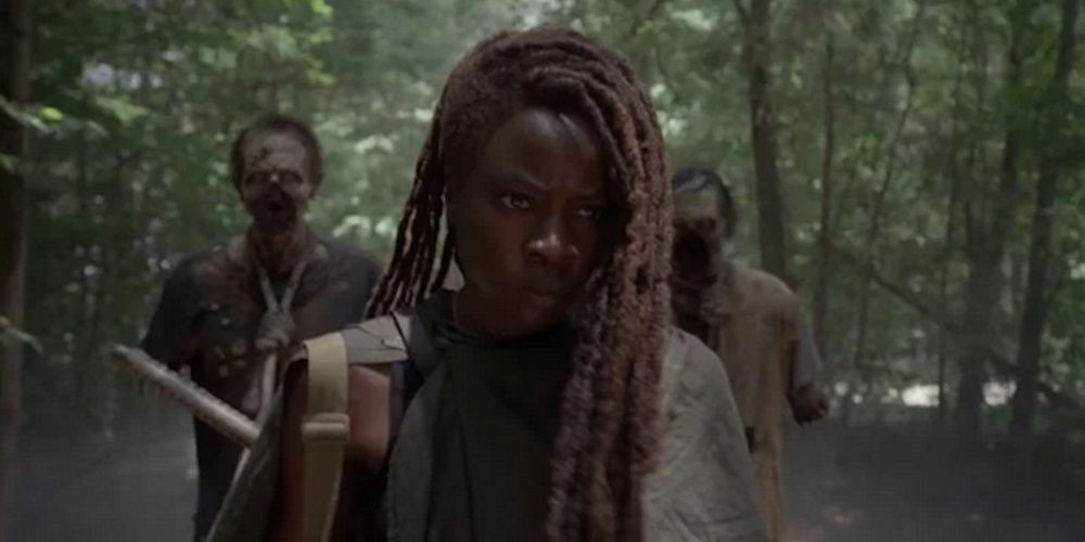 Michonne walking with two walkers in The Walking Dead