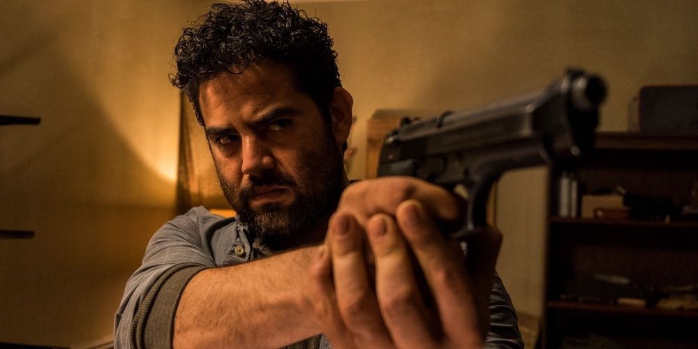 Morales aims a gun in The Walking Dead