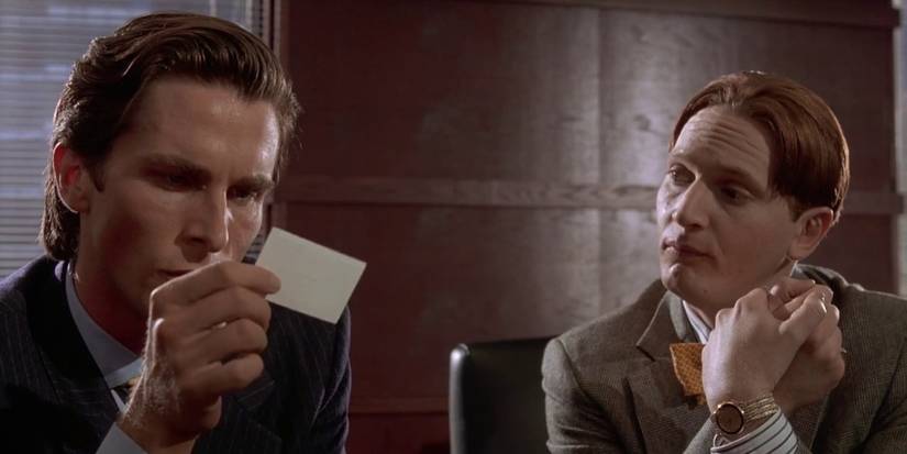 Patrick Bateman looking at Paul Allen's business card in American Psycho.