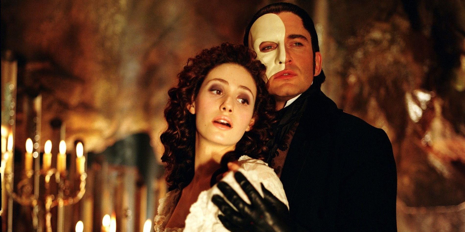 Emmy Rossum being held by Gerard Butler in 2004's The Phantom of the Opera