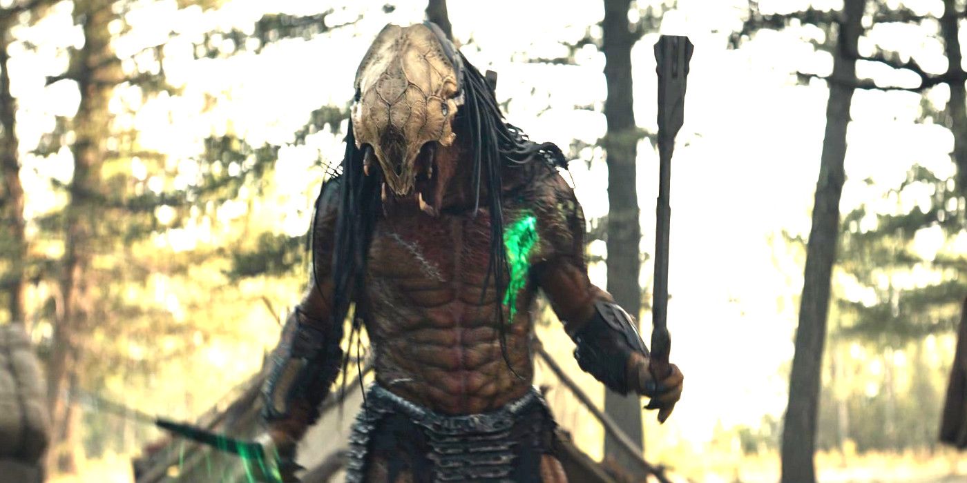 The Predator alien from Prey in the forest with a skull-looking mask on bare-chested with a wound bleeding bright green blood