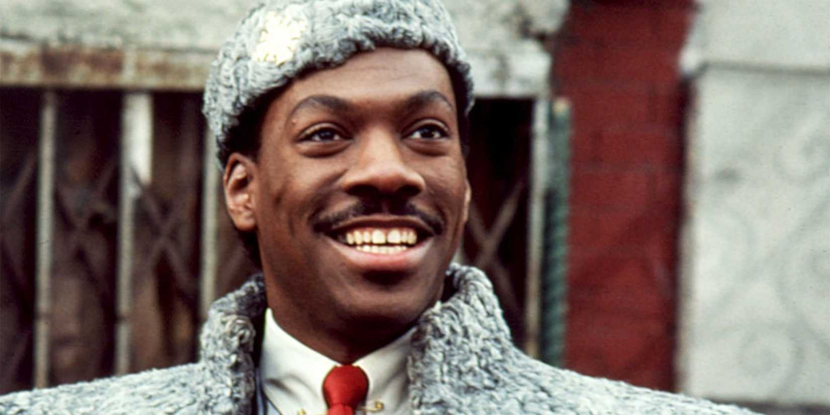 Eddie Murphy as Prince Akeem smiling in Coming to America