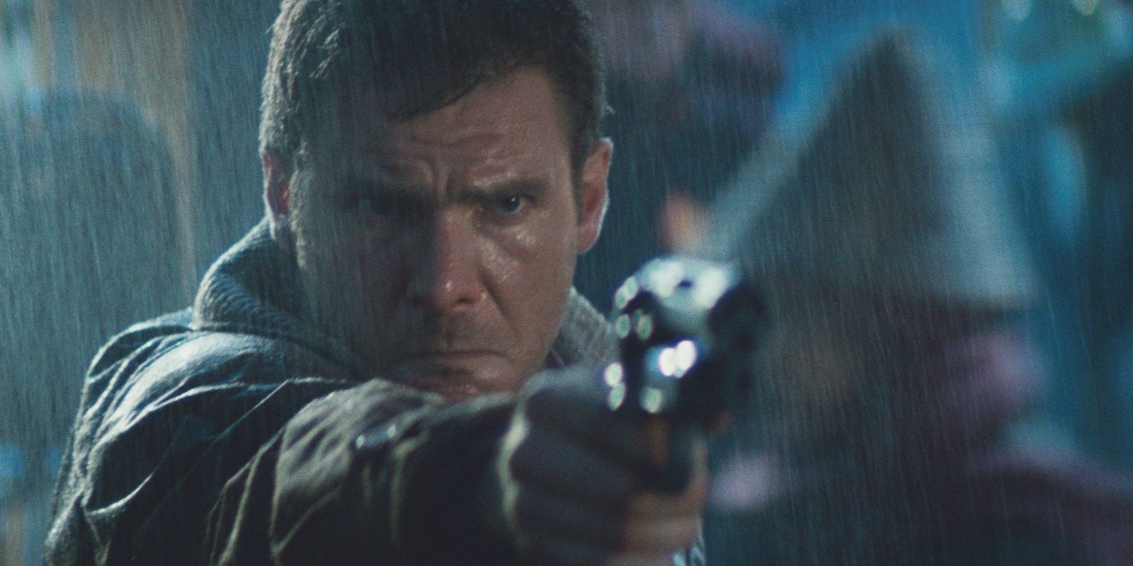 Rick Deckard holding a gun in the rain in Blade Runner