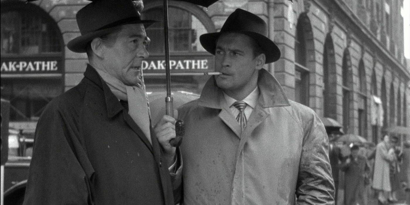 Rififi in the streets of Paris, two characters under an umbrella