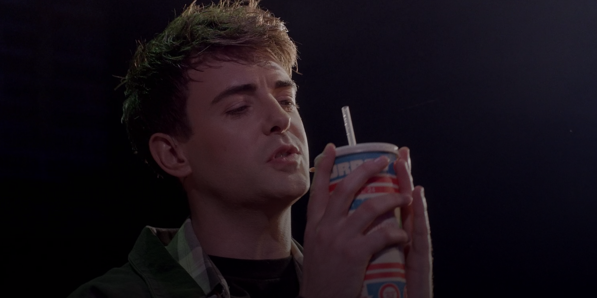 Jason Dean (JD) holding a 7/11 slushie in Heathers: The Musical