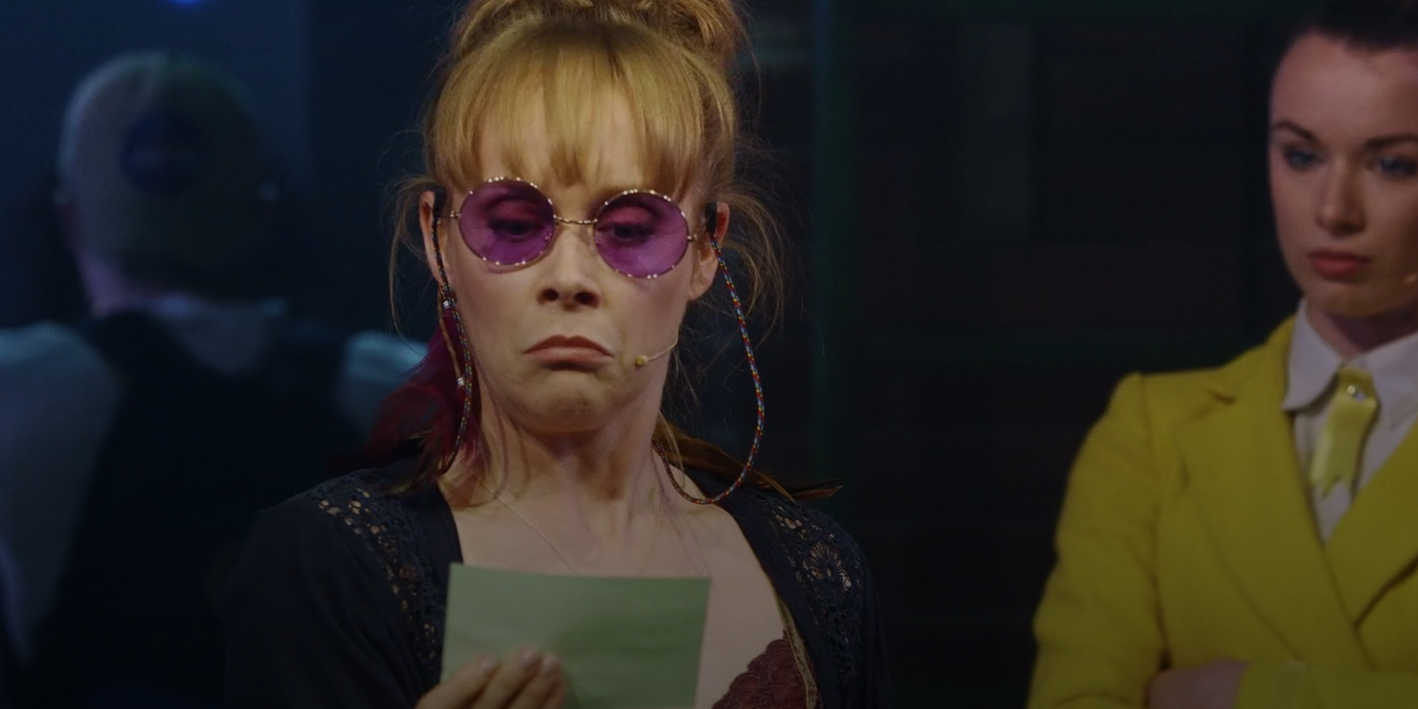 Pauline Fleming looking at a forged hall pass in Heathers: The Musical