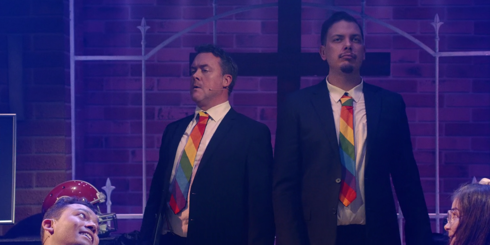 Kurt and Ram's fathers wearing rainbow ties at their funeral in Heathers: The Musical
