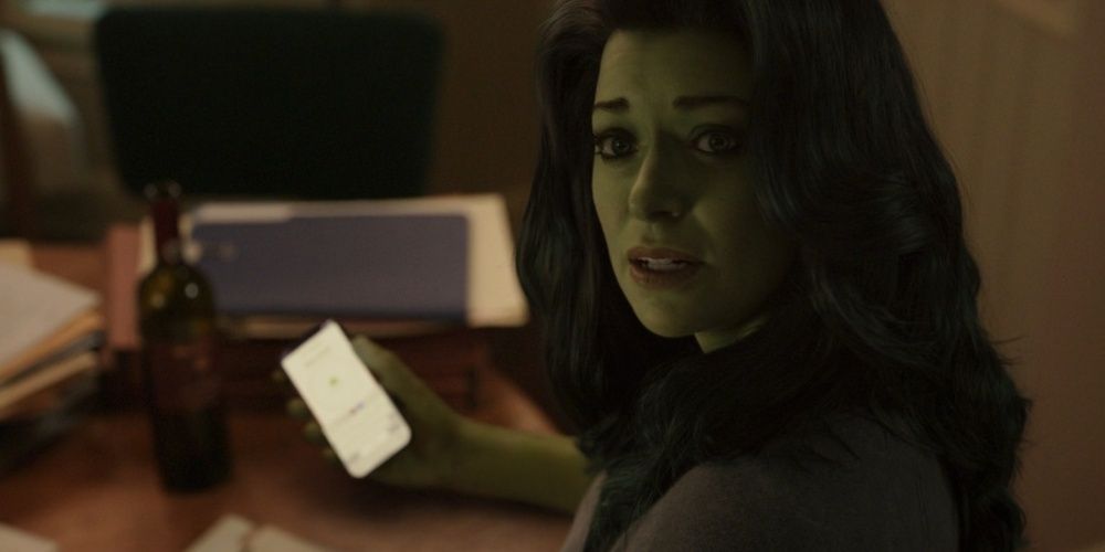 She-Hulk holds a phone and looks in the camera