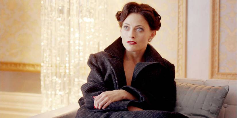 Irene Adler sitting on the couch in Sherlock season 2