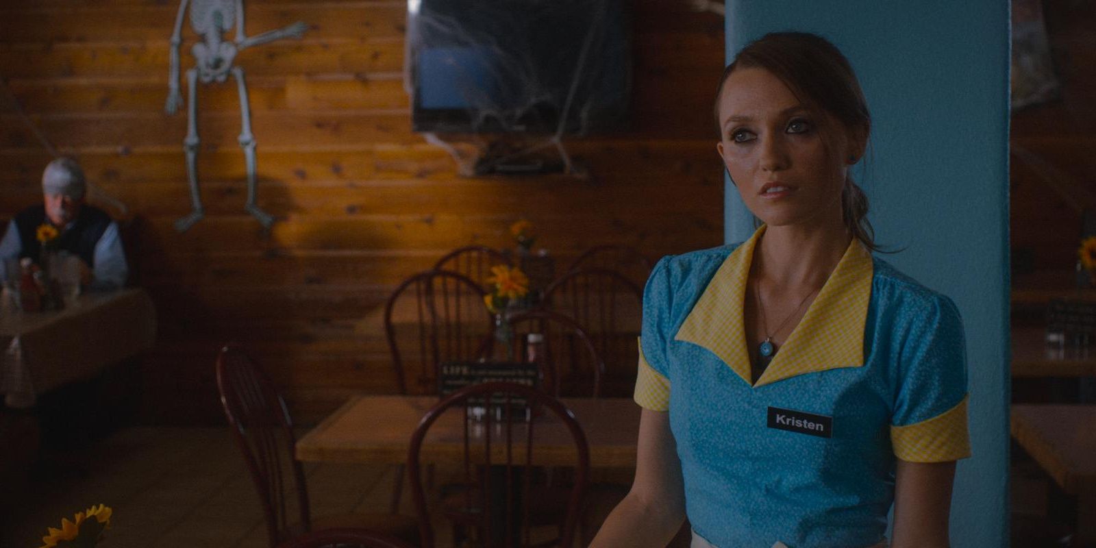 Tabatha Shaun standing and looking sideways in The Guest Cropped