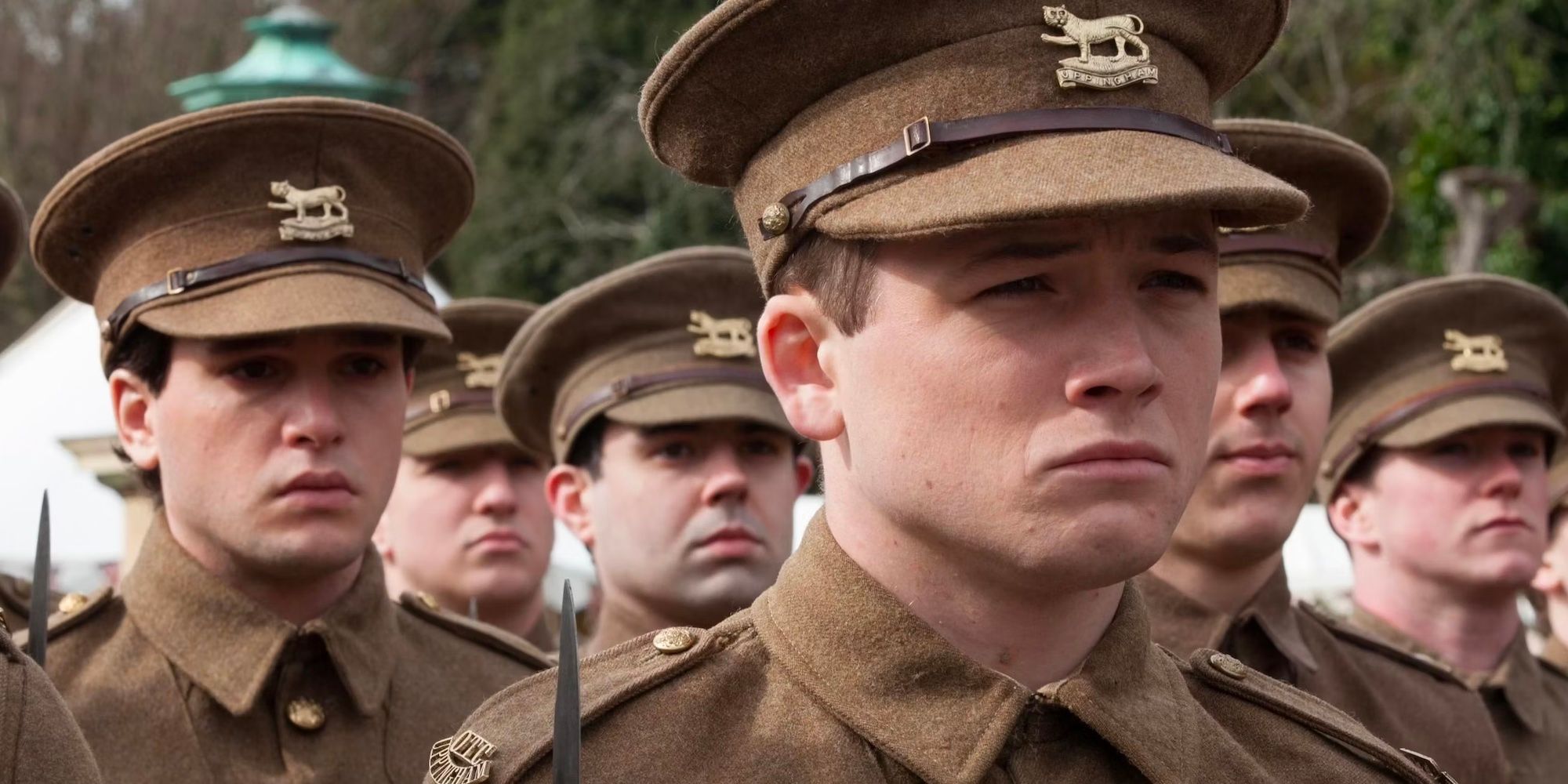 Taron Egerton in uniform in Testament of Youth with Kit Harringon in background