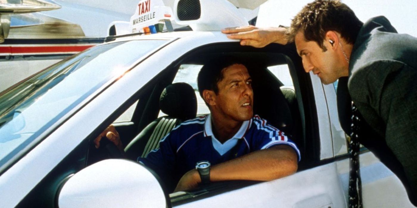 A cop talks to a man inside a car in Taxi 1998.