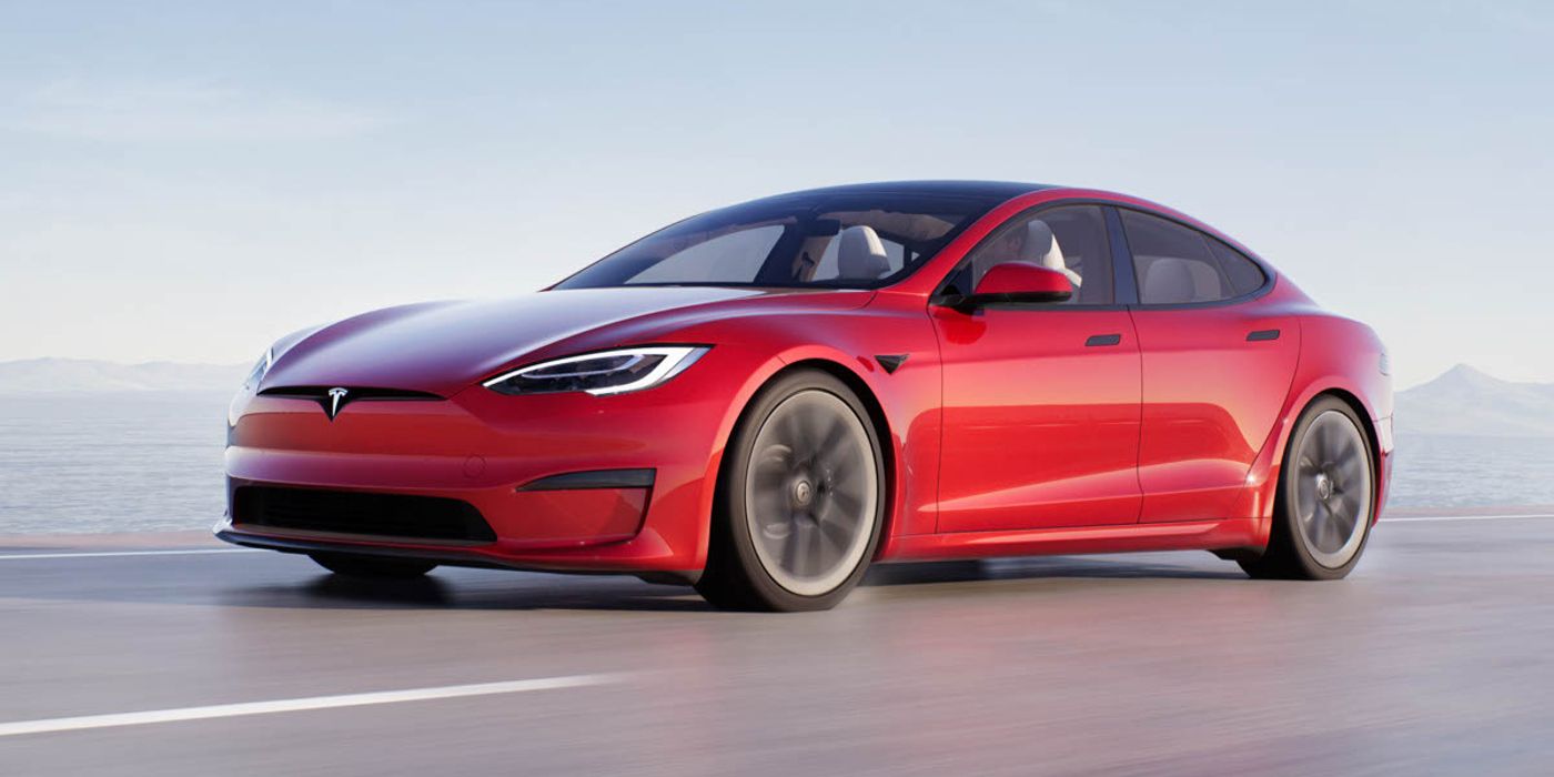 Une Tesla Model S rouge descendant une route.