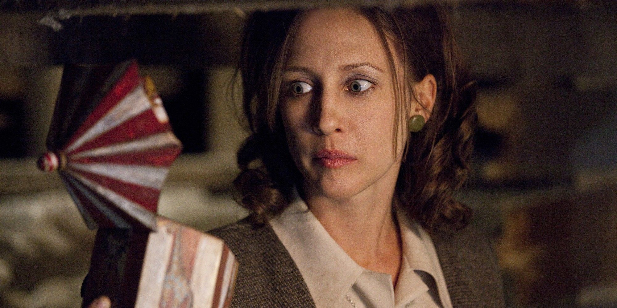 Lorraine holds a music box in The Conjuring (2013).