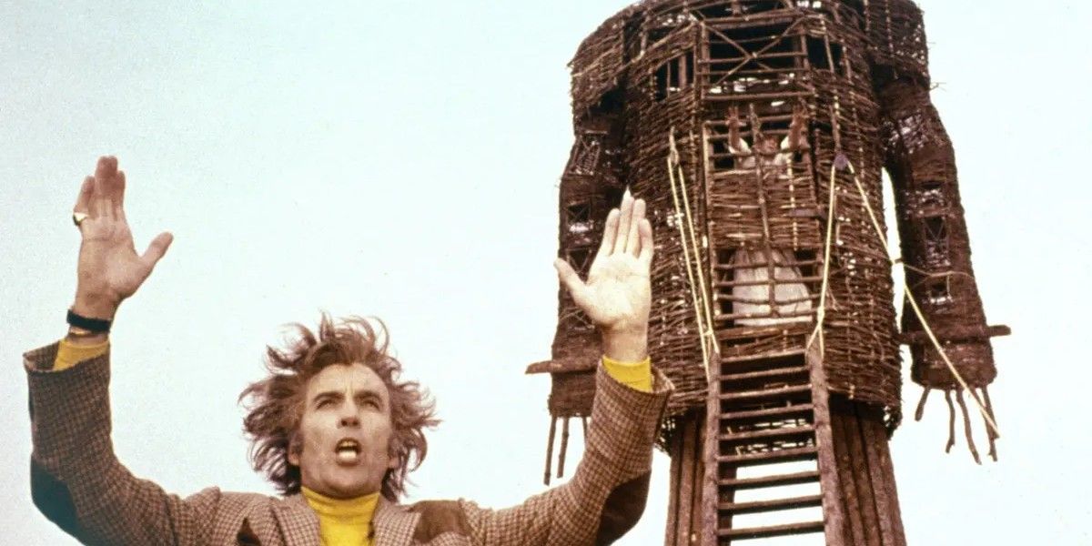 Christopher Lee standing in front of a statue in The Wicker Man