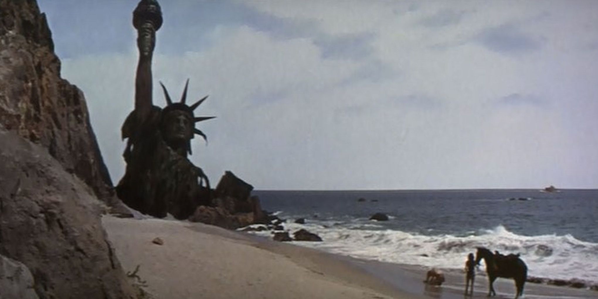The destroyed Statue of Liberty rises out of the sand in Planet of the Apes
