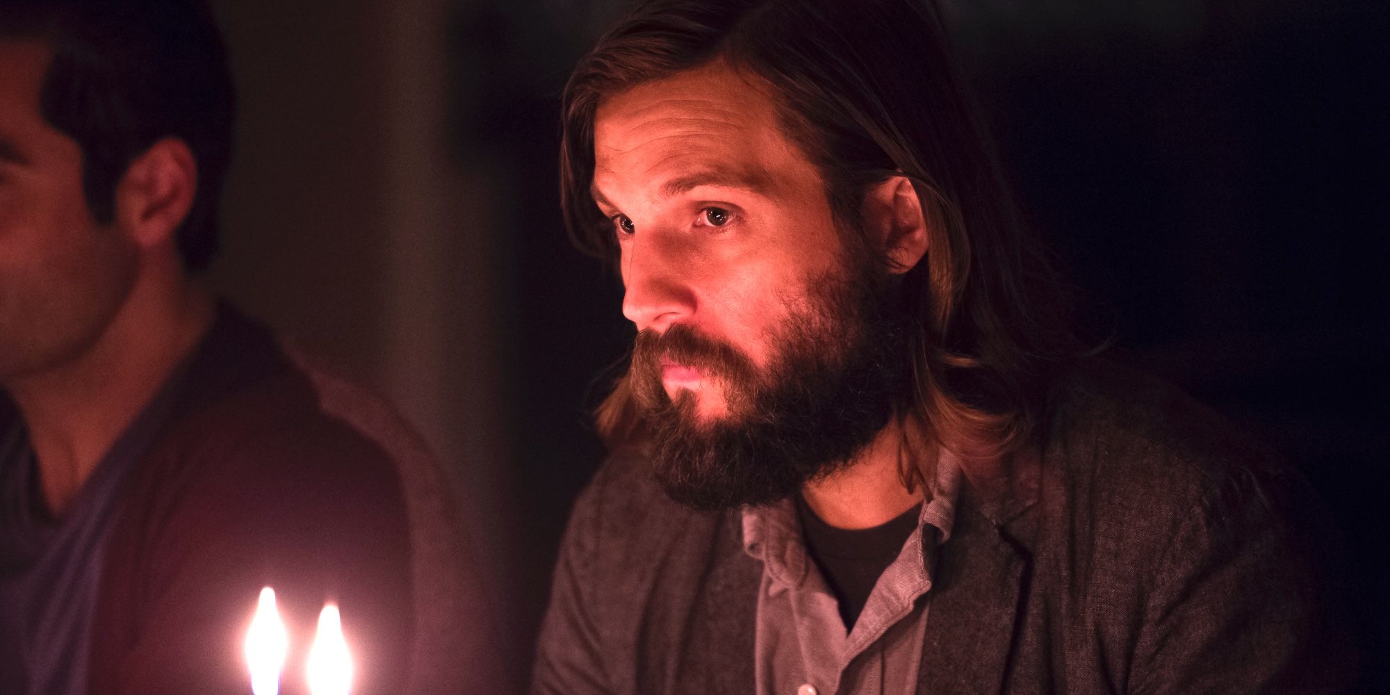 Logan Marshall's Will sits in the dark with a candle in The Invitation