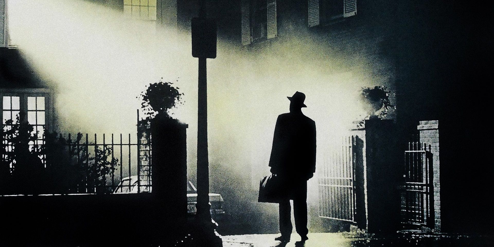 A priest stands in the light of a lamp post from the Exorcist 