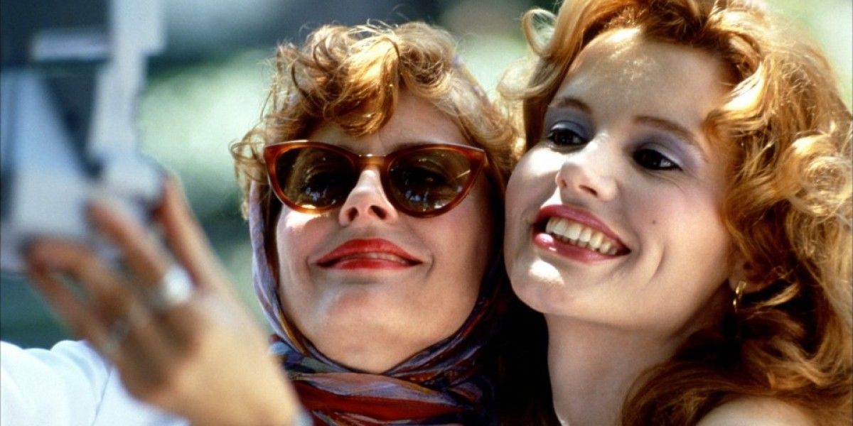 Thelma and Louise smiling while taking a selfie