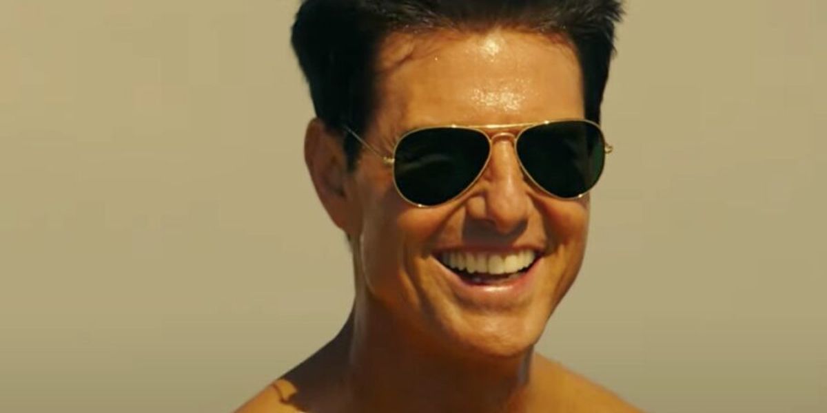 Tom Cruise as Pete &ldquo;Maverick&rdquo; Mitchell playing football on the beach in Top Gun: Maverick