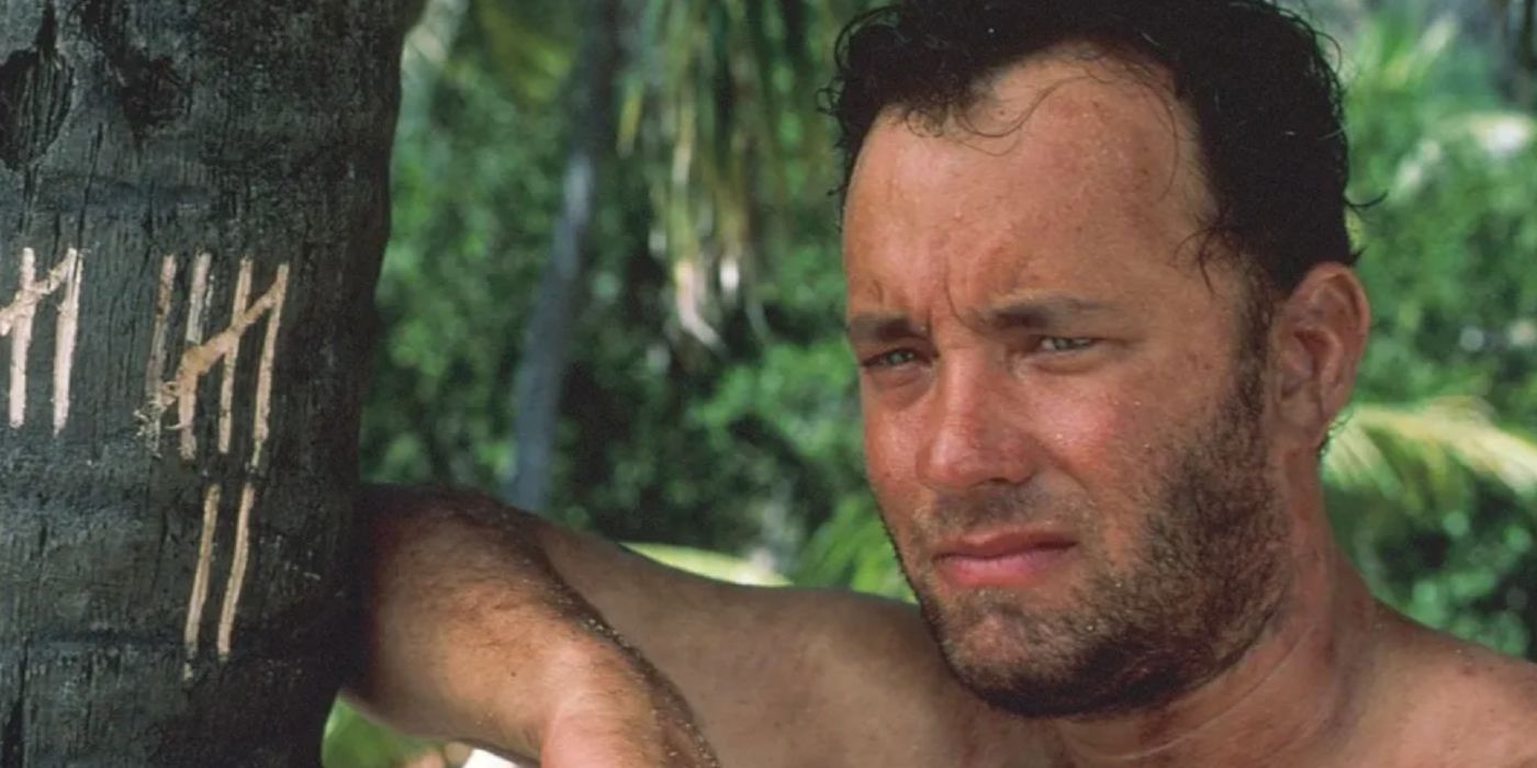 Tom Hanks standing by a tree in Cast Away (2000)